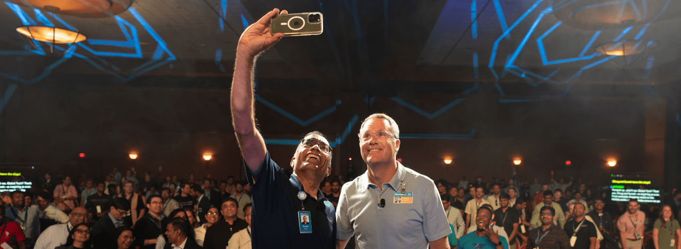Suresh Kumar, EVP, CTO and CDO, Walmart Inc. (on the left) is shown taking a selfie with Doug McMillon, President and CEO, Walmart Inc. (on the right) with the audience in the background.